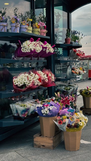 A display of various floral arrangements and bouquets at Flowers Barkingside, featuring fresh flowers in vibrant colors such as pinks, whites, yellows, and purples. The flowers include chrysanthemums,